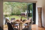 Next to the kitchen and bi-folding glass doors onto the deck, you'll find a teak dining table for four