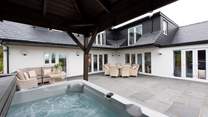 The hot tub is handily close to the house, whilst others can choose to relax on the outside furniture