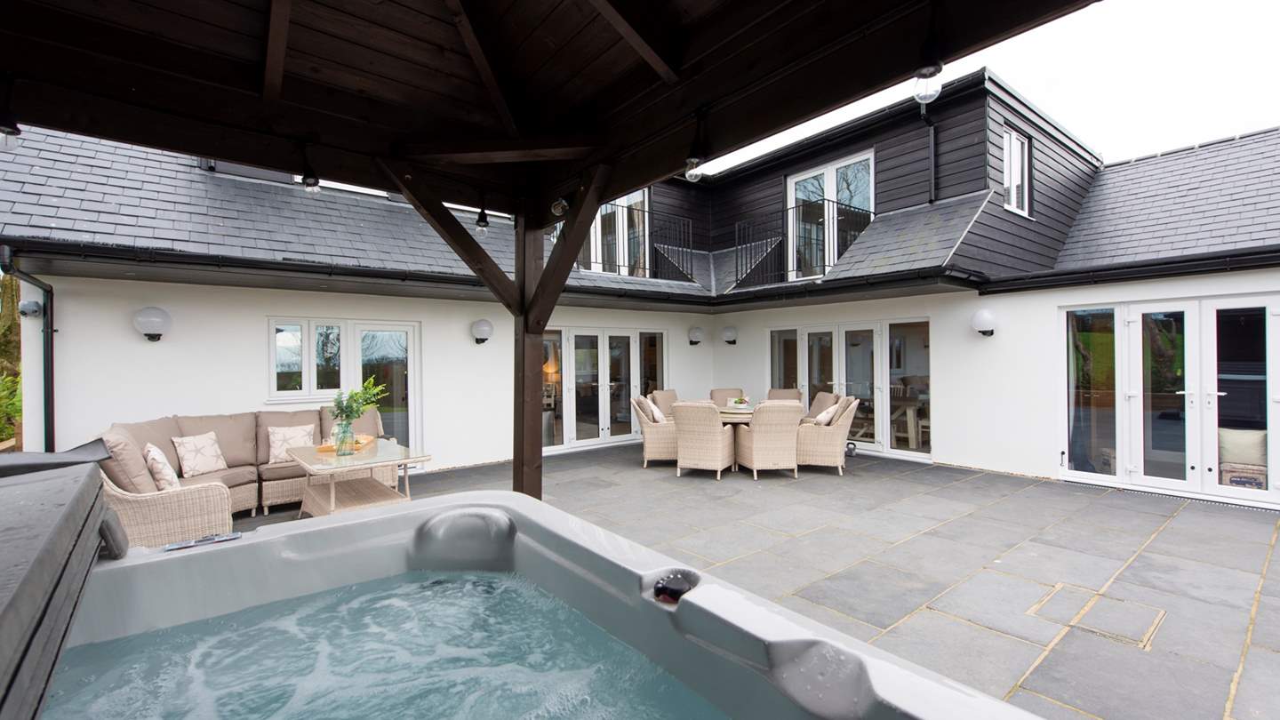 The hot tub is handily close to the house, whilst others can choose to relax on the outside furniture