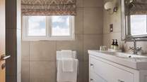 The en suite has a rainfall shower for relaxing after a day exploring