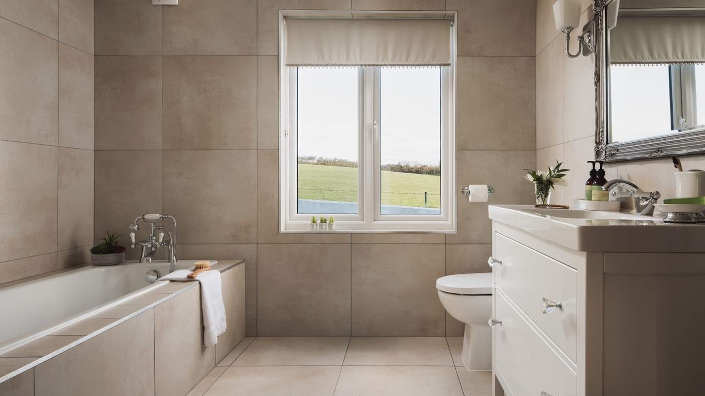 The ground floor family bathroom with a deep bath and separate rainfall shower