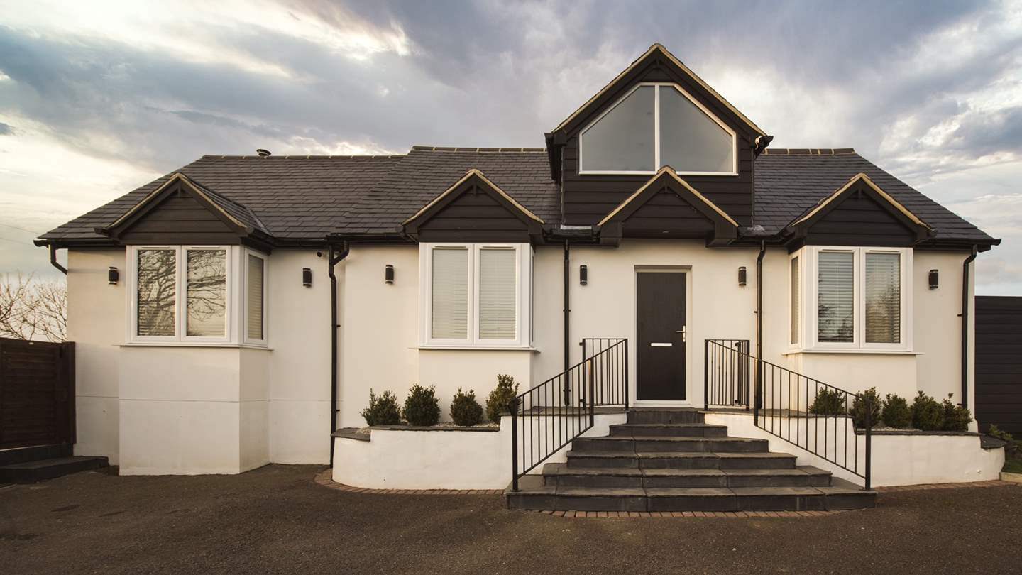 The front of Treetop Cottage with plenty of private parking set behind an electric gate