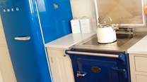 You'll find a sweet Aga, a royal blue Smeg fridge, and a Nespresso coffee machine for morning pick-me-ups