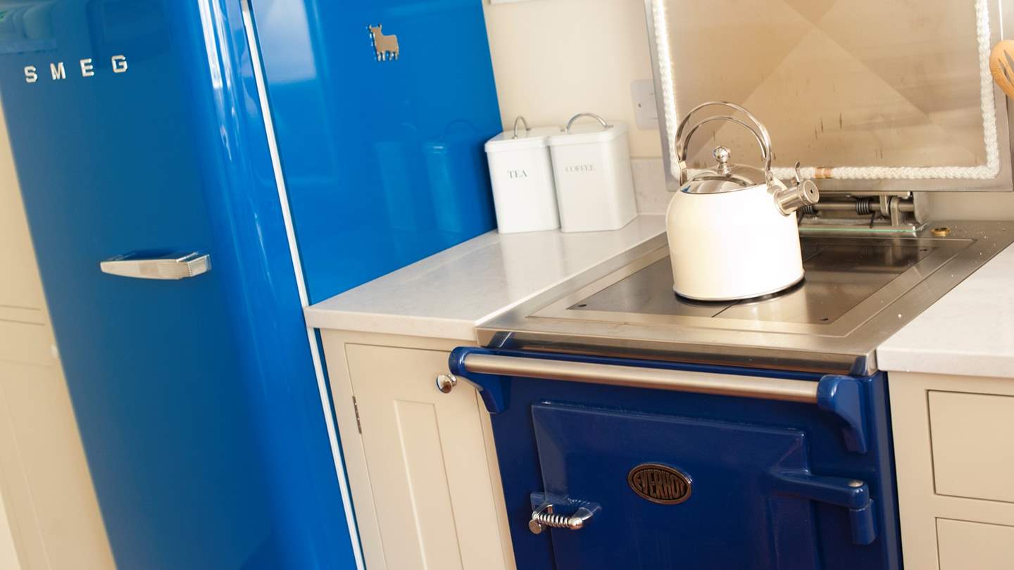 You'll find a sweet Aga, a royal blue Smeg fridge, and a Nespresso coffee machine for morning pick-me-ups