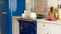 You'll find a sweet Aga, a royal blue Smeg fridge, and a Nespresso coffee machine for morning pick-me-ups
