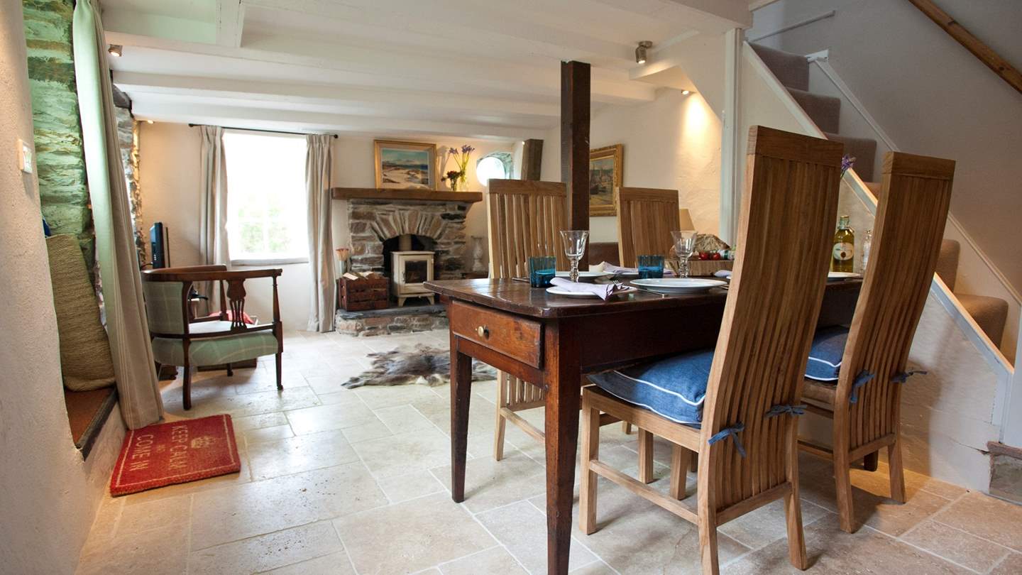 The open-plan dining and living area is lovingly decorated with the perfect blend of traditional and contemporary touches 