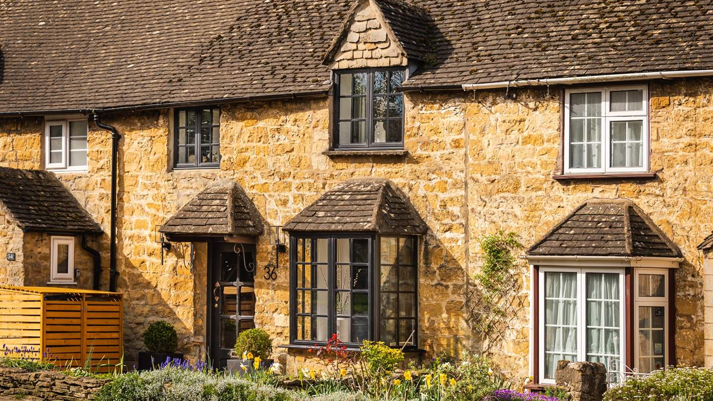 This gorgeous Cotswold cottage offers a warm welcome within its sandstone walls