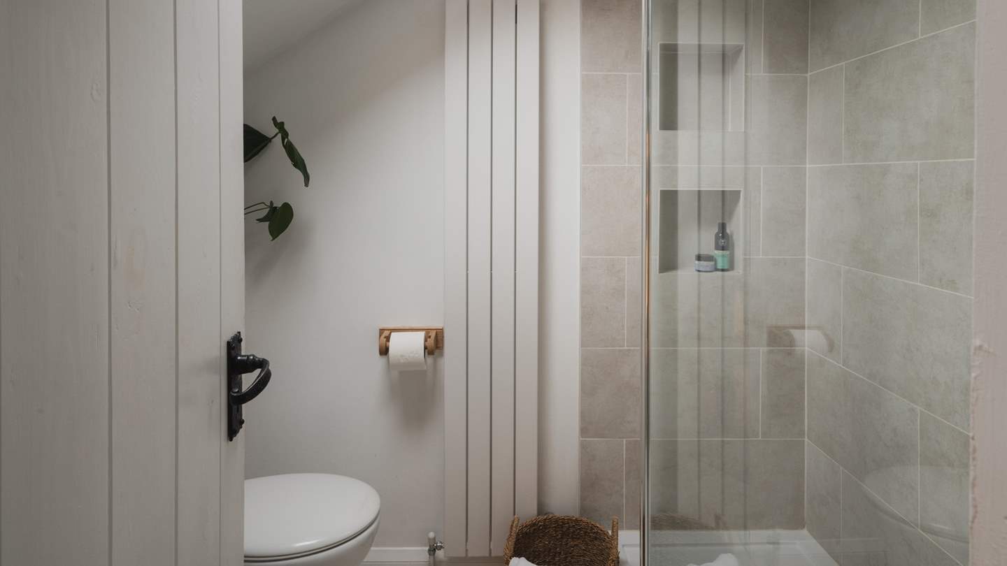 Take a soothing soak under the walk-in shower complete with rainfall shower and handheld head