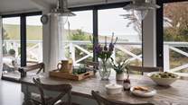 The kitchen is simply a dream, with huge bi-fold windows overlooking the sea that open during warmer months onto the impressive terrace