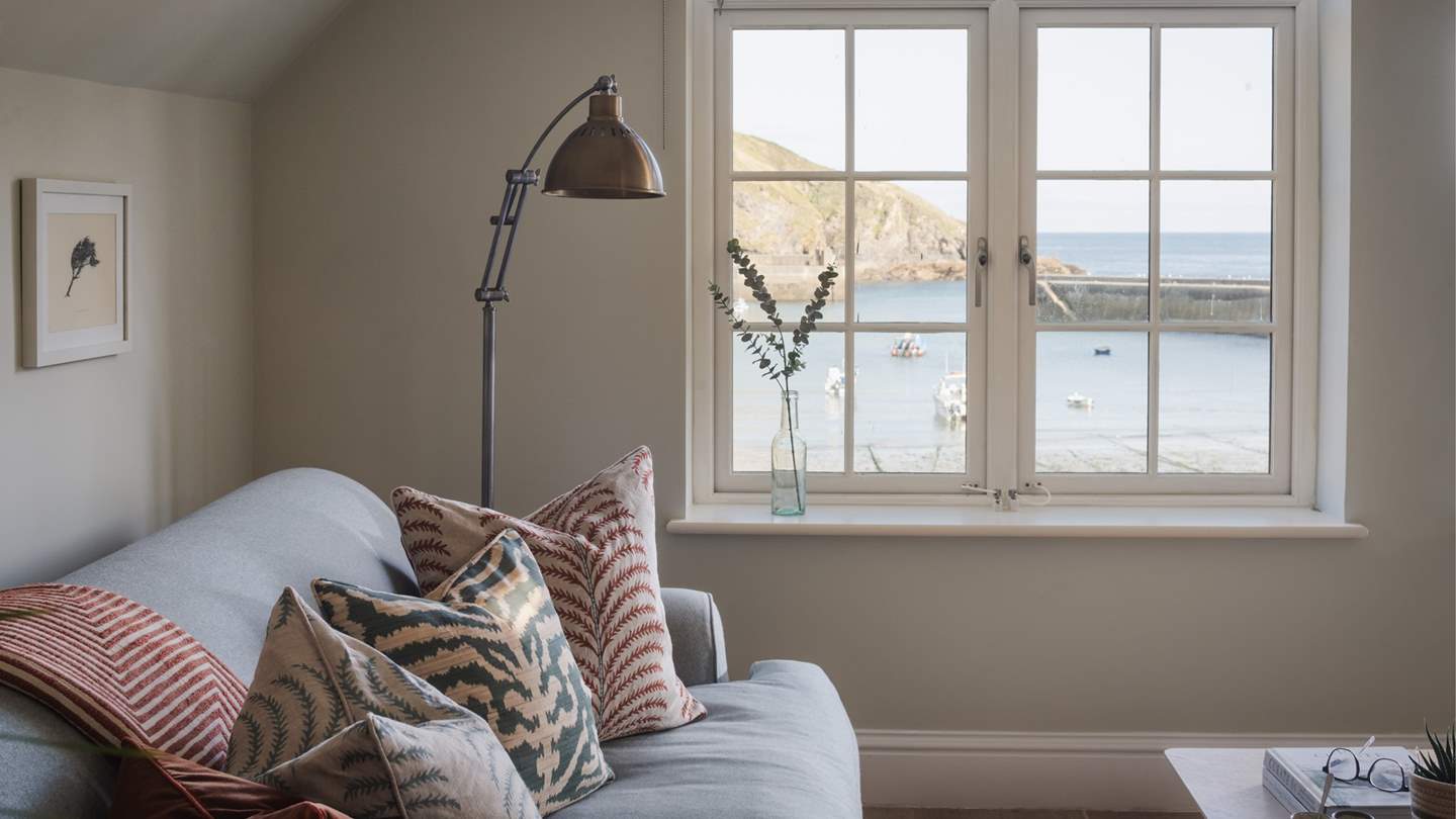 Taking pride of place, two large windows directly overlook the harbour on one side, with additional windows facing the village