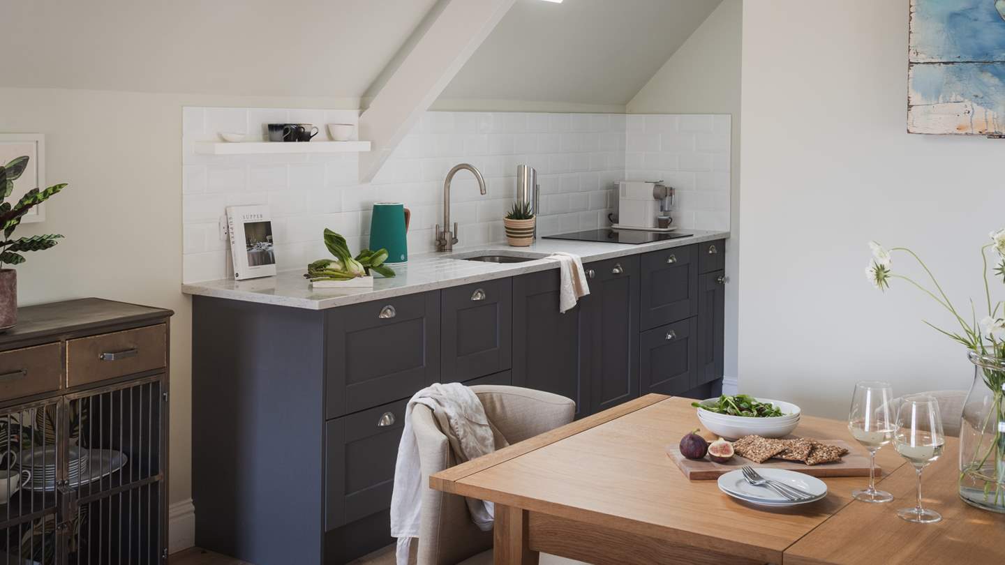 Styled in an open-plan design, the lounge adjoins a kitchen and dining area that pair the same tranquil tones and coastal-luxe décor