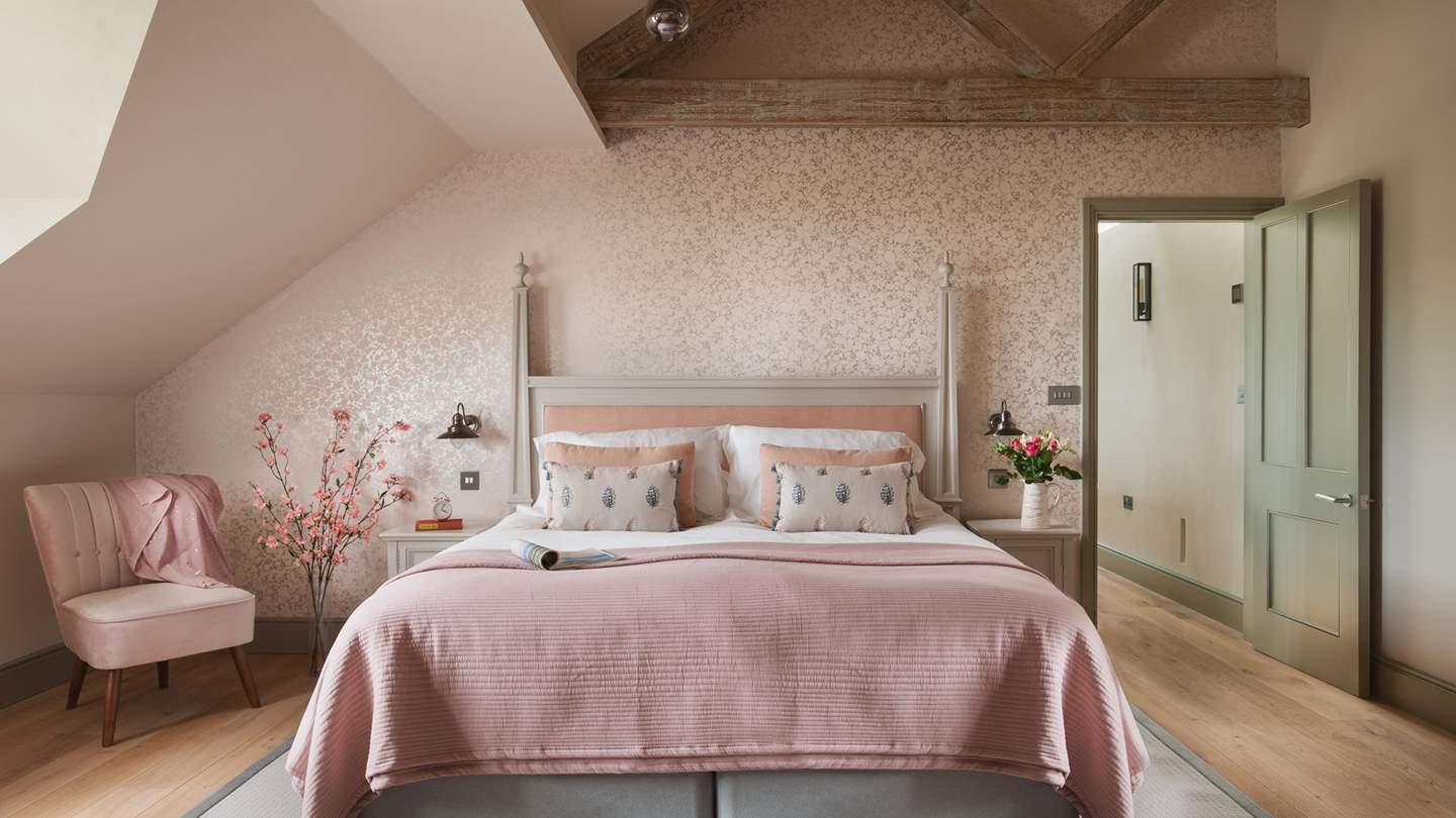 Bedroom two in pretty shades of dusky pink and silver, complete with a super-king bed and triple-aspect windows