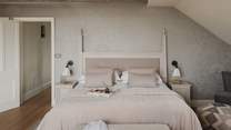 Exposed beams and sumptuous soft linens beckon for blissful slumbers...