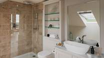 Complete with a large walk-in shower and freestanding bath, for refreshing moments 