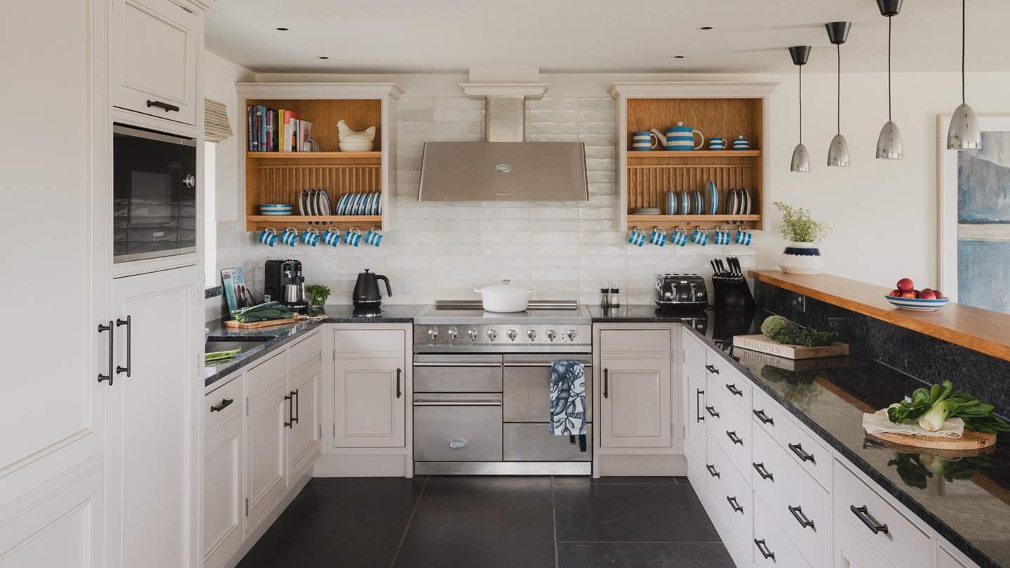 The heart of the kitchen is the immense La Canche cooker with induction hob, whilst the gorgeous white porcelain tiles, hand-crafted cabinets and worktop, makes this kitchen a total joy to cook in
