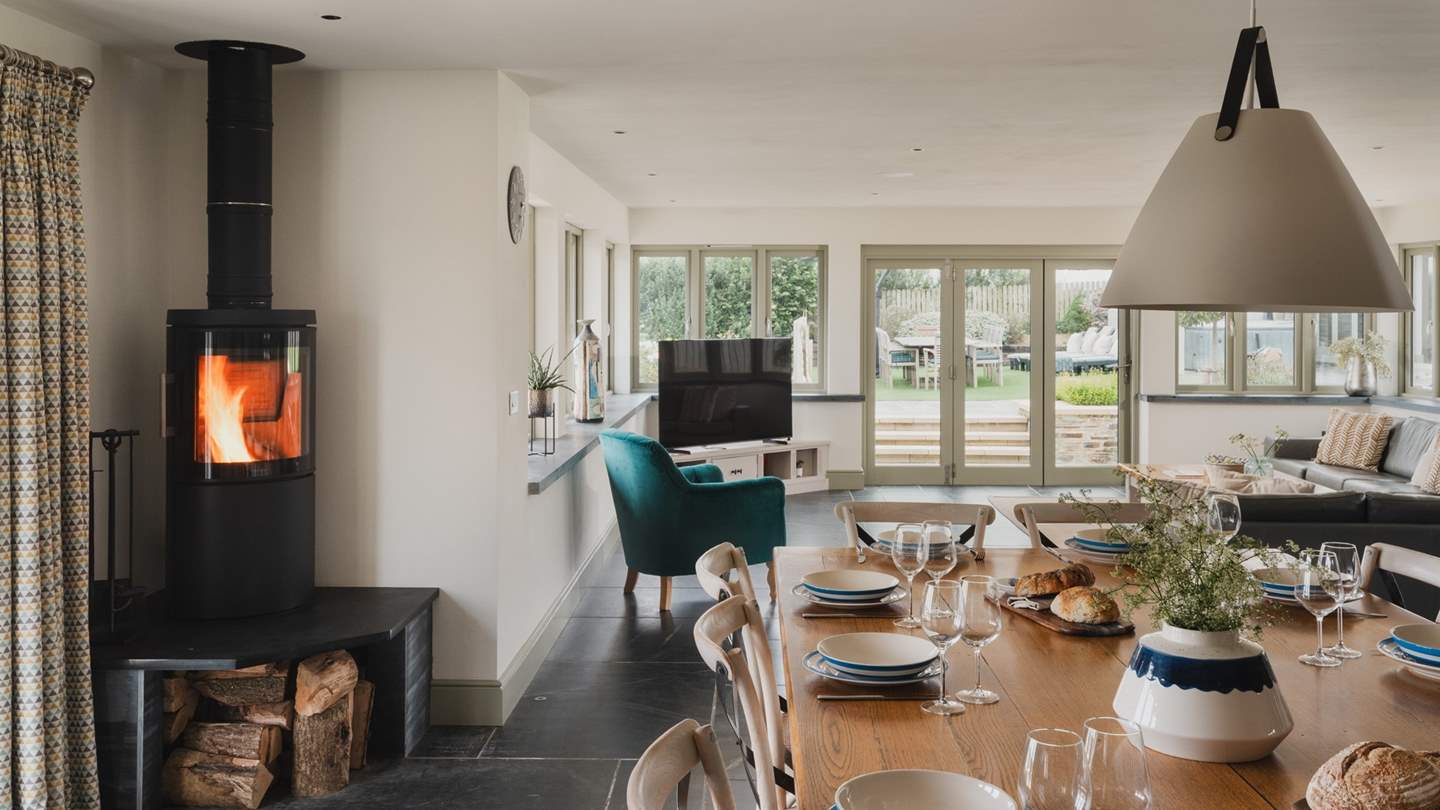 Eye-catching slate floors with underfloor heating and glass windows ensures this is a sunny, warm space complete with a wonderful wood burner for instant cosiness