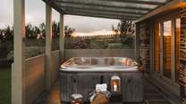 For soaks under starry skies, a outdoor hot tub resides in the corner, a perfect place to watch the sunset