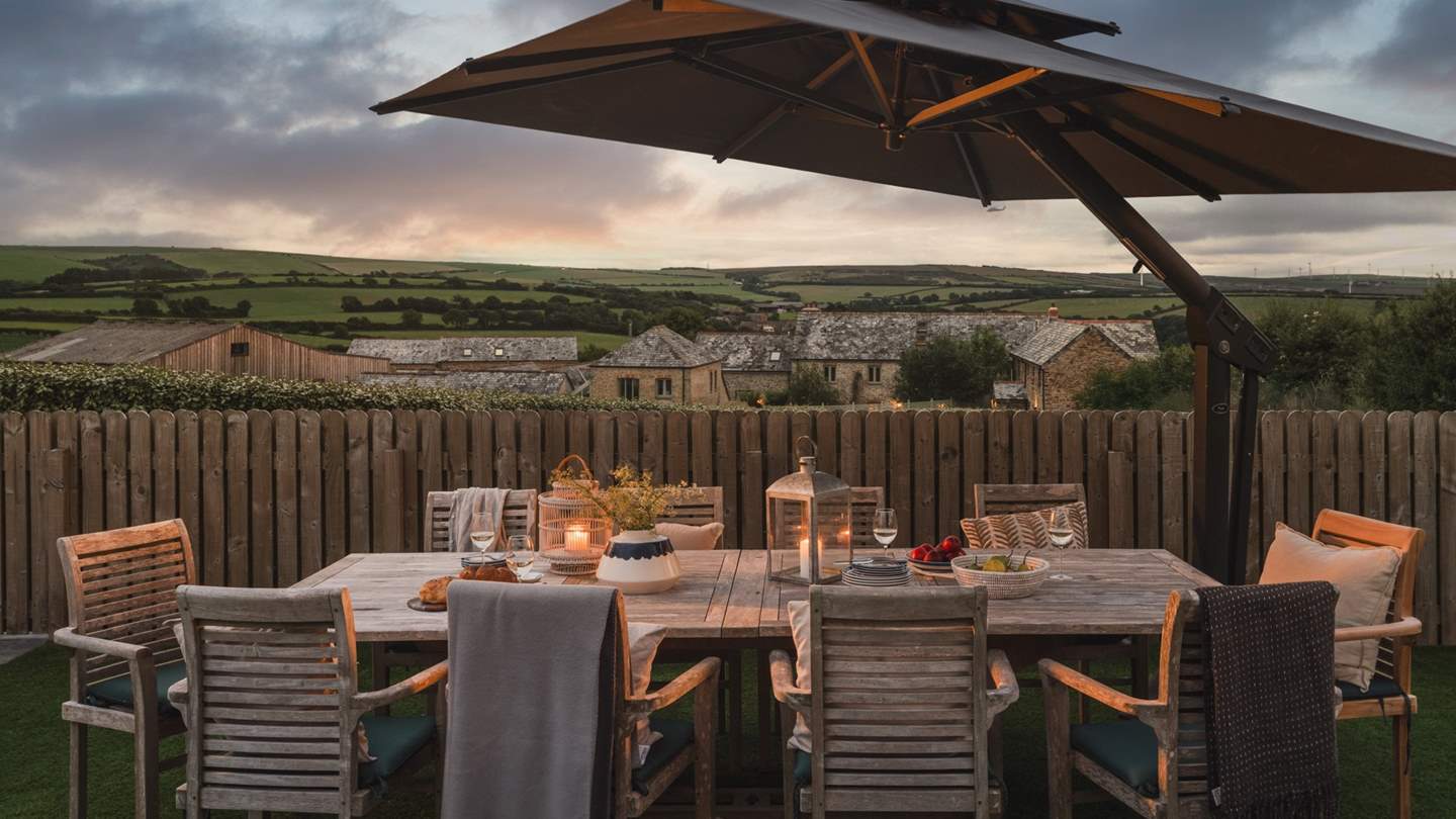 Savour sundown moments alfresco around the wooden outdoor dining table for up to 10 guests