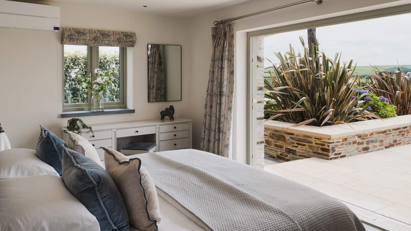 Patio doors frame the gorgeous garden views and in the summer months, you can push the doors open to enjoy the balmy breeze