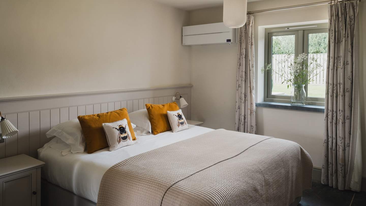 With a beautiful wood panelled headboard, the fourth bedroom is a calming space for lingering lie-ins