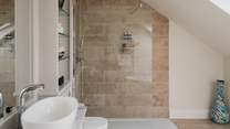 Completing the picture, a luxury en suite with walk in shower and freestanding bath