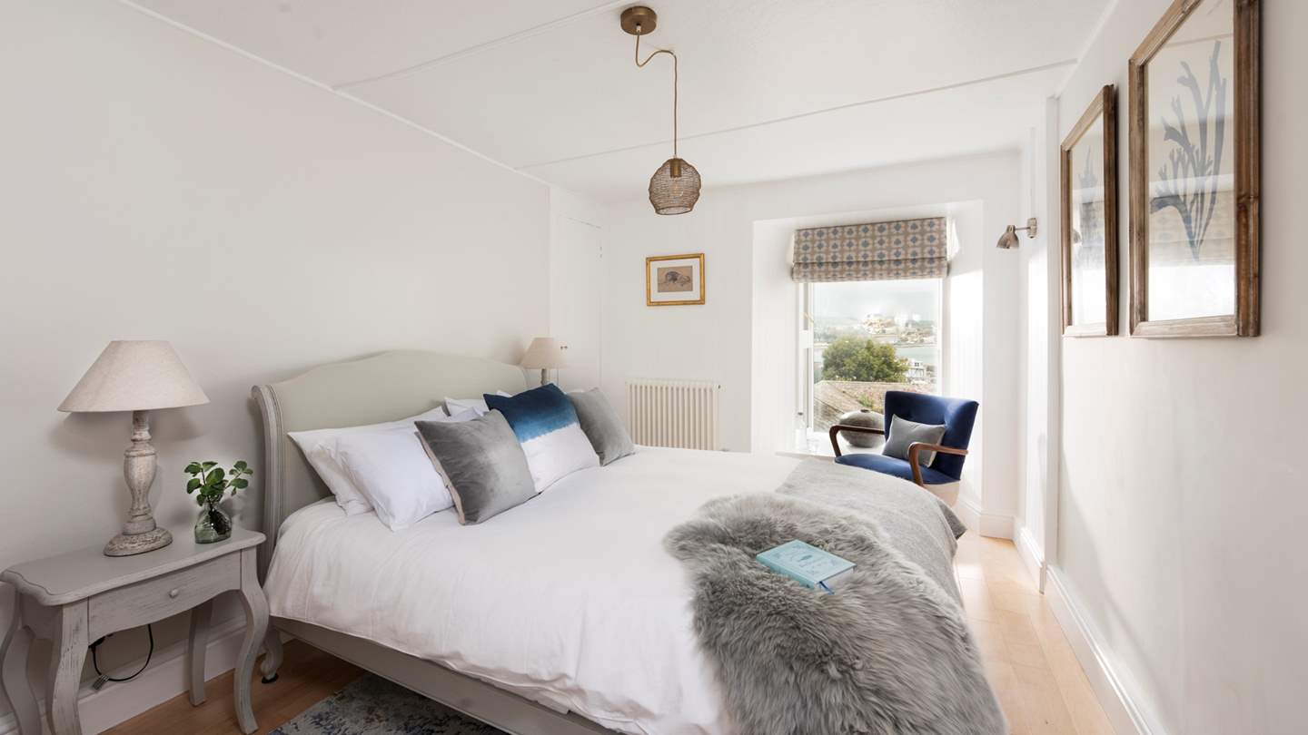 The master bedroom lies to the front of the property and boasts lovely sea views which you can gaze at from the sumptuously cosy king-size bed