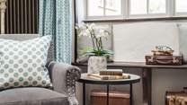 Take a moment to curl up in the pretty armchair with a good book