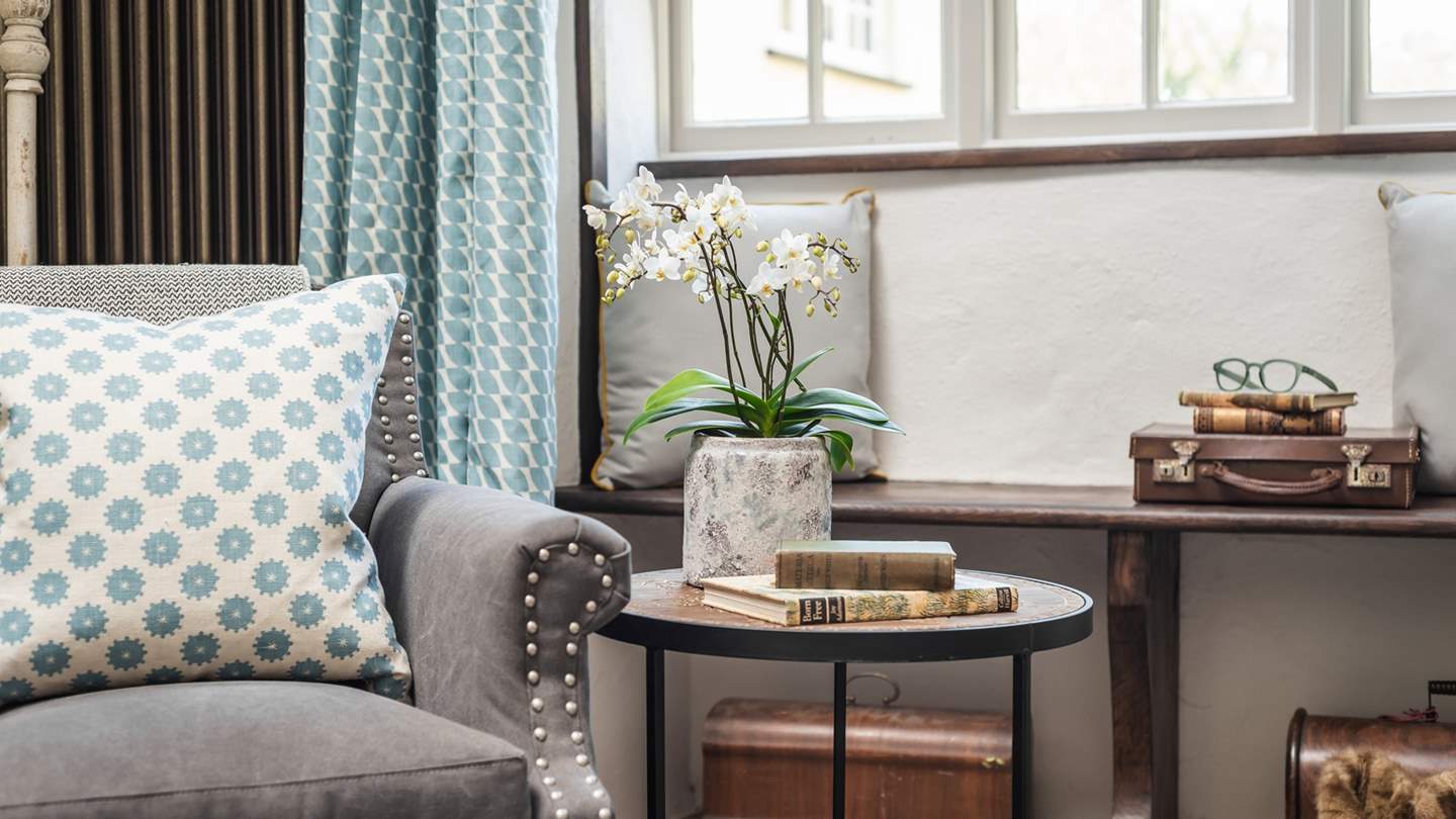 Take a moment to curl up in the pretty armchair with a good book