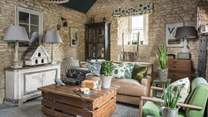 The gorgeous sitting room with its botanical touches and exposed stone walls is just a delight