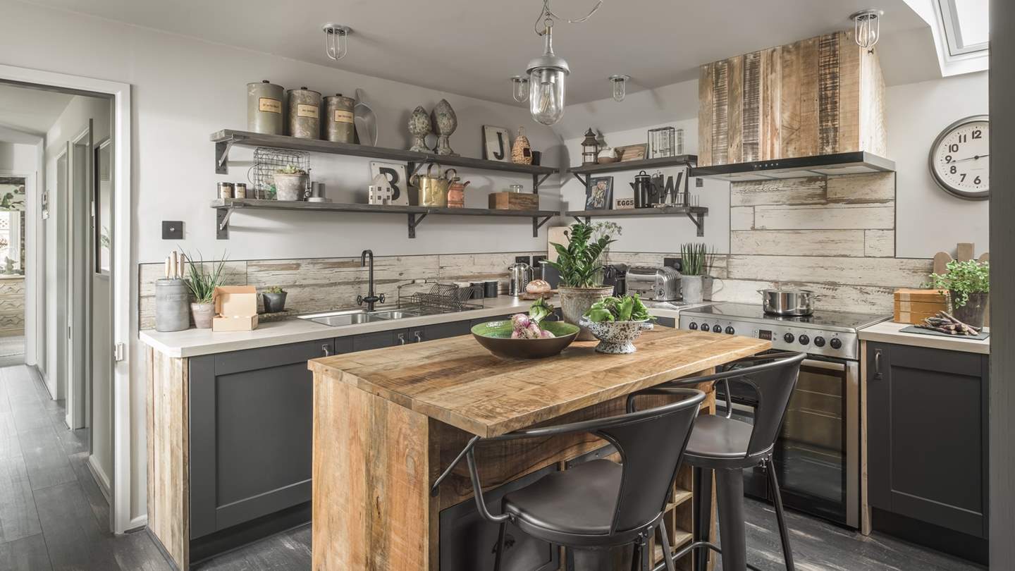The gorgeous kitchen in shades of grey and natural wooden touches is just a dream to cook in