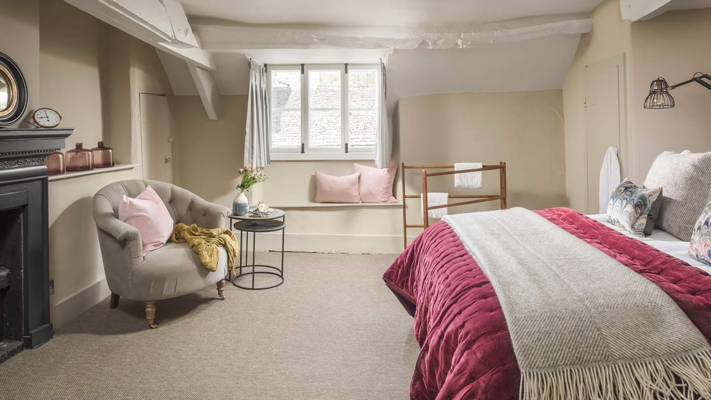 Take the winding wooden stairs up and you'll find two charming bedrooms to choose from