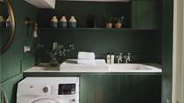 The sweet utility space finished in a rich forest green, offers a perfect spot to stow away your belongings after a day of exploring