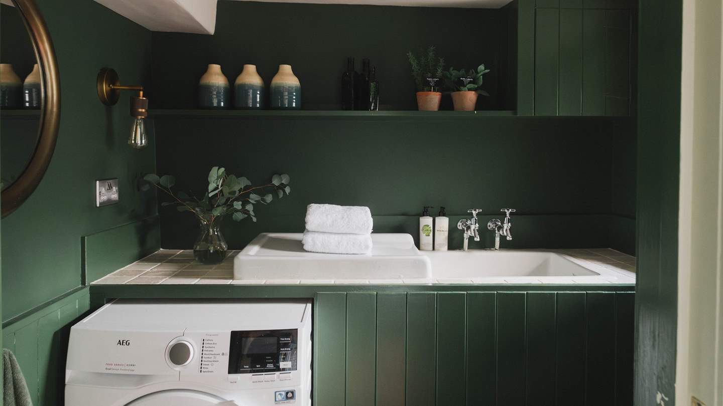The sweet utility space finished in a rich forest green, offers a perfect spot to stow away your belongings after a day of exploring