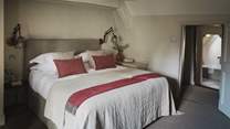 The generous Master bedroom boasts a seriously sumptuous super king bed, a wonderful window seat and fireplace
