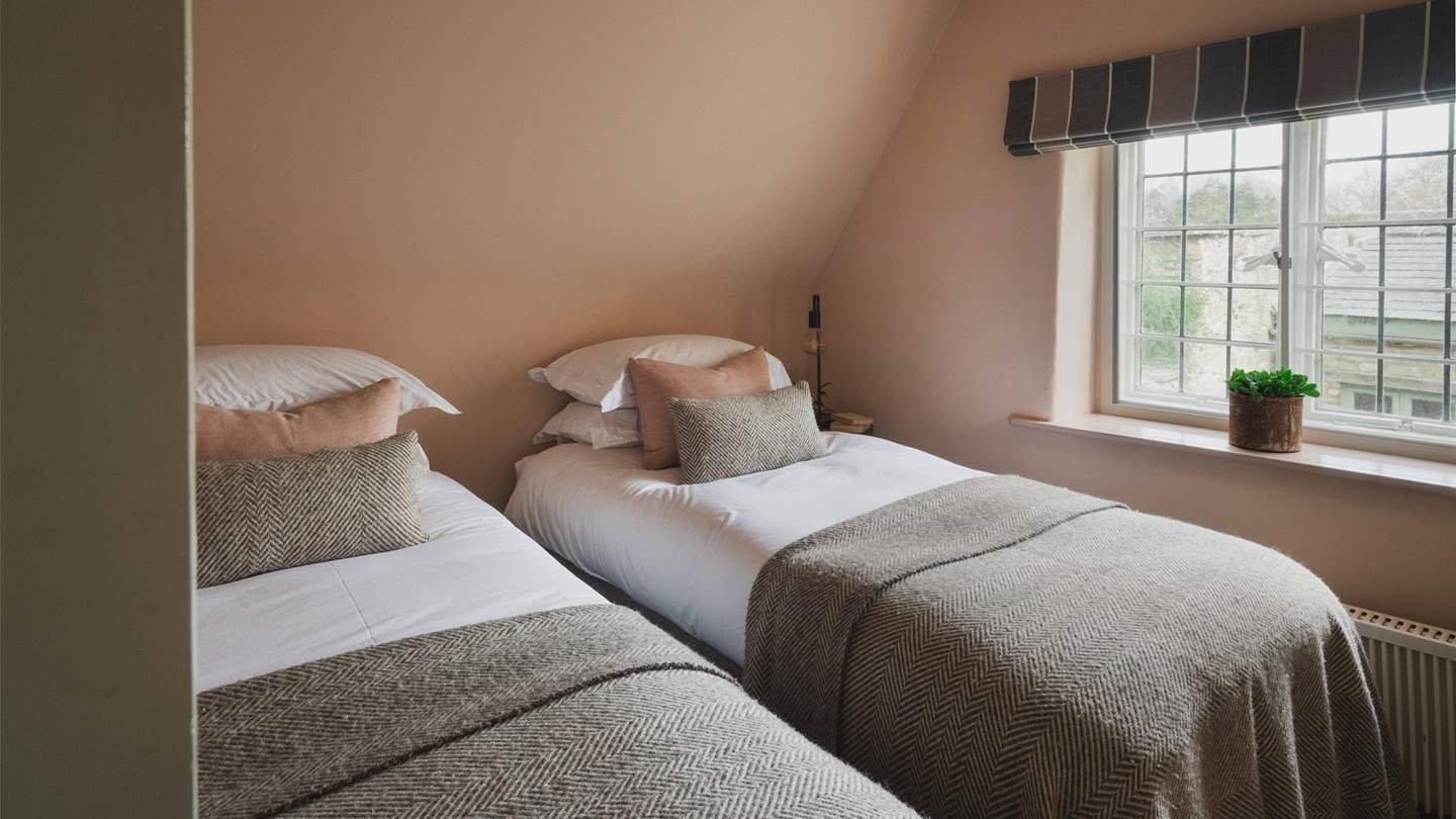 The second, smaller bedroom, in glorious shades of dusky pinks and greys, has a zip-and-link bed meaning it can be made into twins or a super king bed