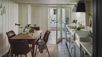 The vintage dining table lies in the kitchen and has four gorgeous leather chairs