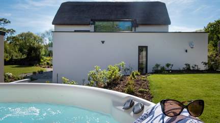 Relax in the wonderful hot tub, nestled in the gorgeous gardens