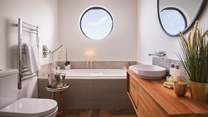 The pretty family bathroom with bath and separate shower - and fabulous porthole!