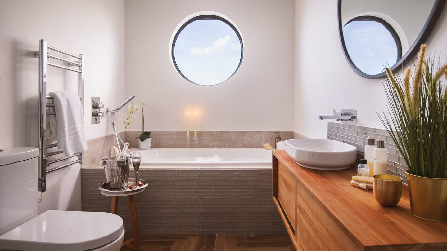 The pretty family bathroom with bath and separate shower - and fabulous porthole!