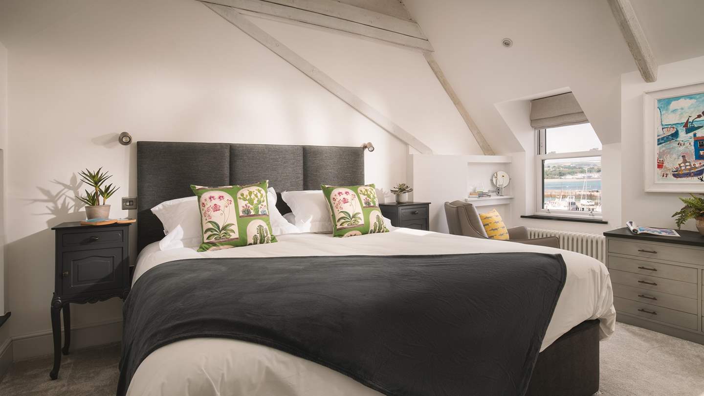 The master bedroom is gloriously spacious with a beamed vaulted ceiling, a luxurious super-king 6ft bed