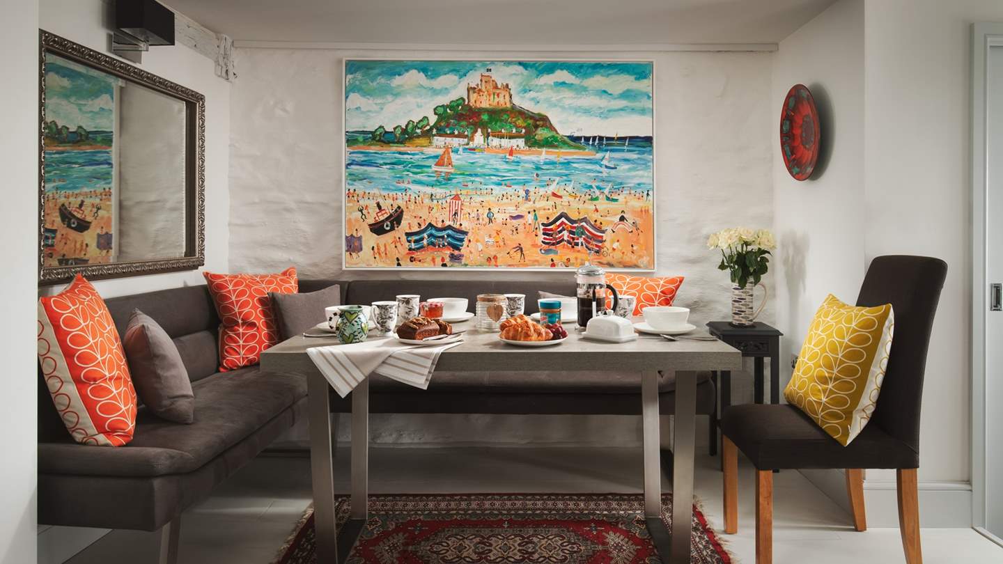 Raised above the sitting room you'll find the dining area, complete with plenty of soft seating