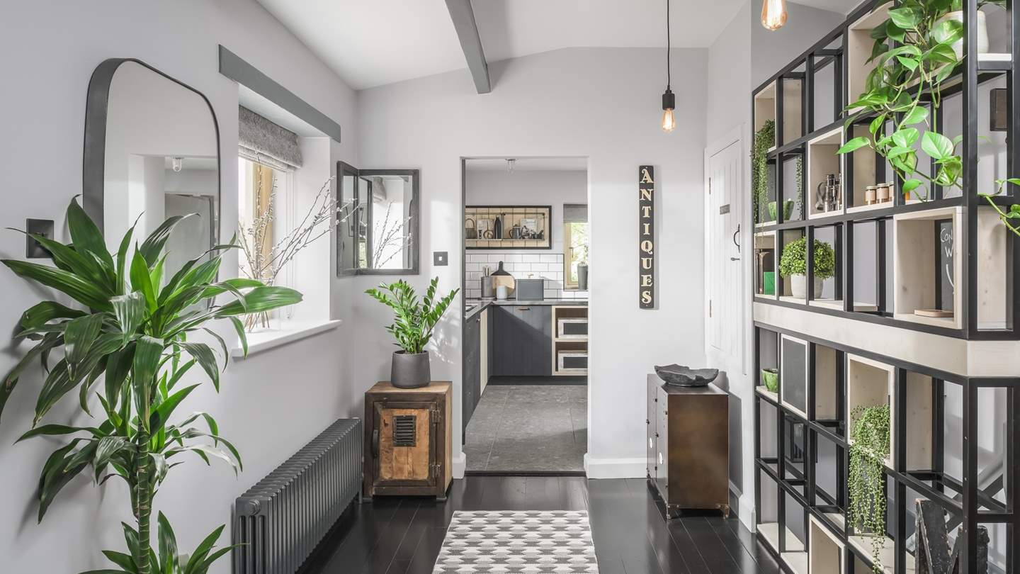 With monochrome tones throughout with splashes of green, this is a stunning, chic retreat