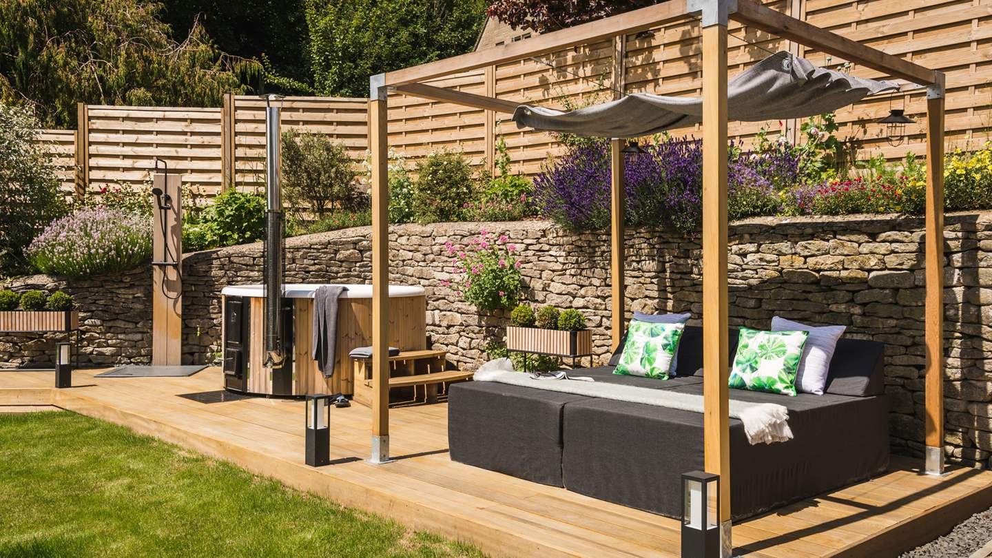 How gorgeous is this day bed, set next to the bubbling hot tub for ultimate relaxation!