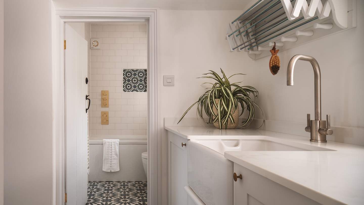 The family bathroom has a bath with shower overhead - and a utility room outside