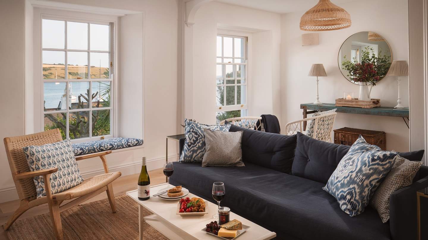 The extra-long sofa and occasional chairs offer plenty of space to sprawl out and gaze through the windows