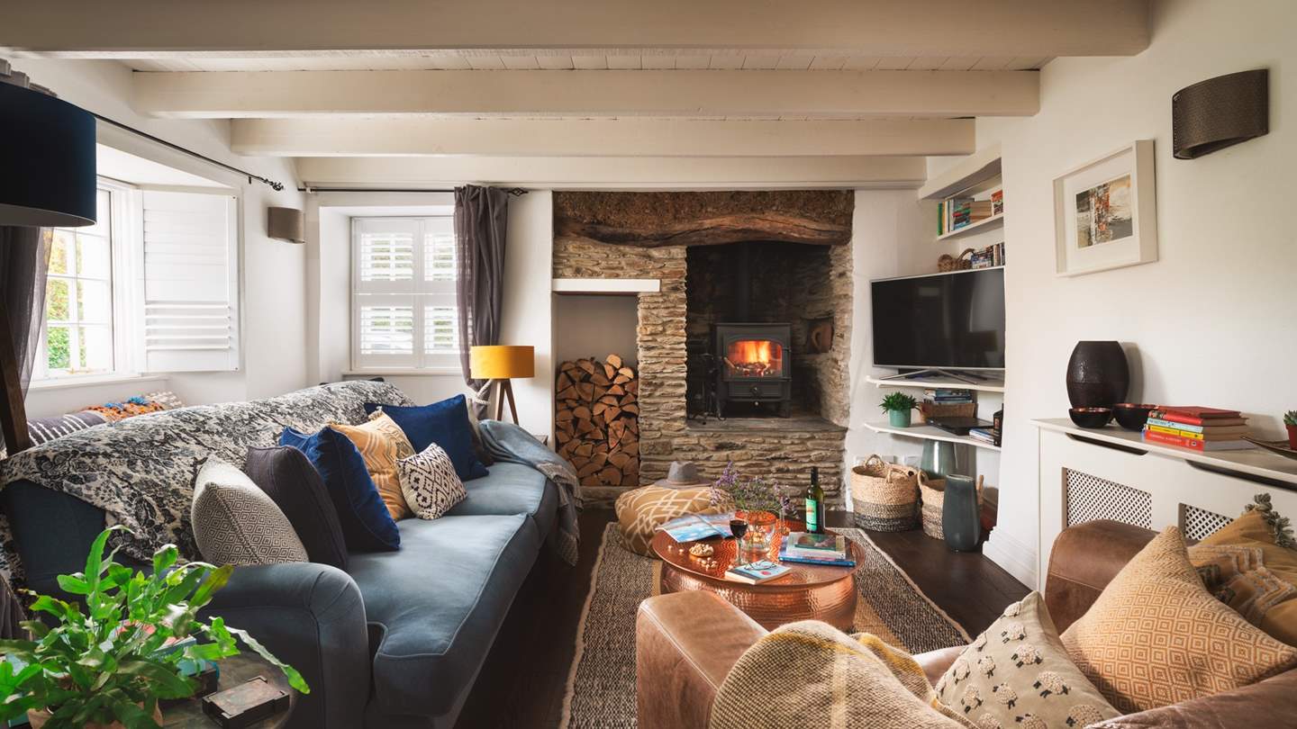 The supremely cosy sitting room just invites cosy nights in - and that woodburner!