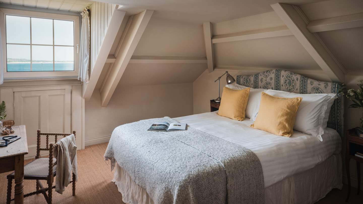 You'll find find a pretty double bed with a wrought iron bed upholstered in GP & J Baker fabric 