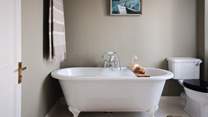 Uncover the beautiful bathroom, complete with a rolltop bathtub for two
