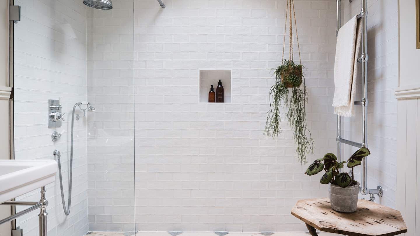 A luxurious shower room with French limestone tiles and Lefroy Brooks shower fittings awaits on the ground floor
