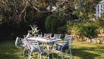 On the front lawn, you'll find a Petersham Nurseries dining table for alfresco moments with your party 